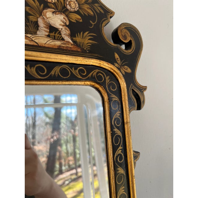 Italian, circa 1960. A well decorated black and gold chinoiserie decorated wall mirror in the chippendale taste. Mirror...