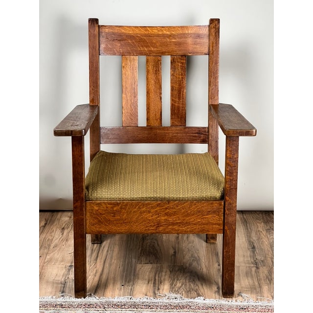 This really great Mission oak arm chair by Quaint Furniture dates to the early 20th century and embodies the...