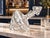 An eye-catching clear cut crystal decanter featuring a distinctive tilted silhouette, a broad rounded body tapering to a...