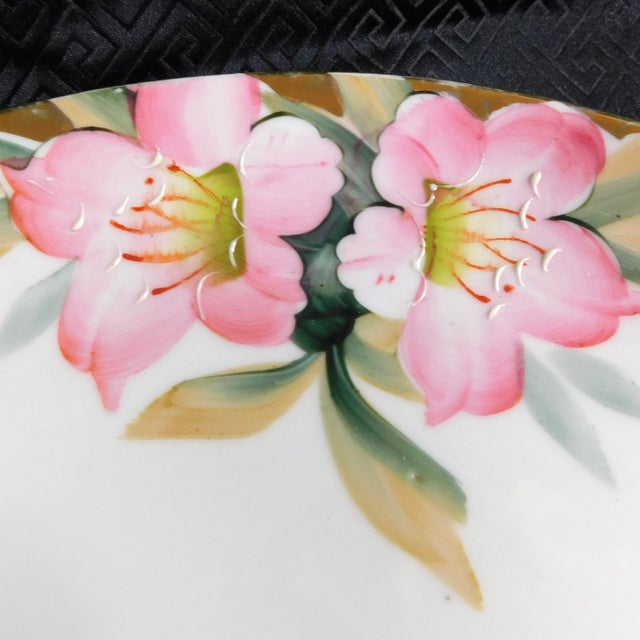 This is a handled cake plate or serving tray by Noritake in the Azelea pattern from 1918. The tray is round with two gold...