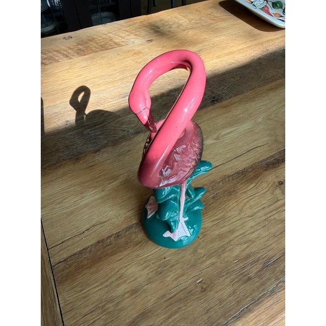 Bright pink flamingo above tropical green foliage, neck loops gracefully to perfectly frame any standard taper candle....