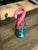 Bright pink flamingo above tropical green foliage, neck loops gracefully to perfectly frame any standard taper candle....