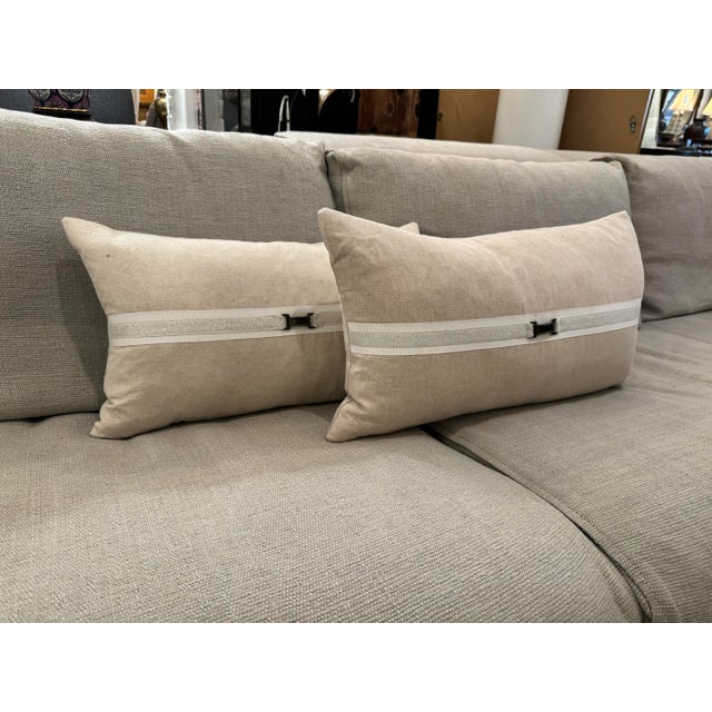 Design Plus Gallery presents a Pair of Taupe Buckle Lumbar Pillows from the Thom Filicia Home Collection. The rectangular...