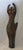 This authentic figurative piece features a stylized, fluid female form with arms raised in an abstract silhouette....