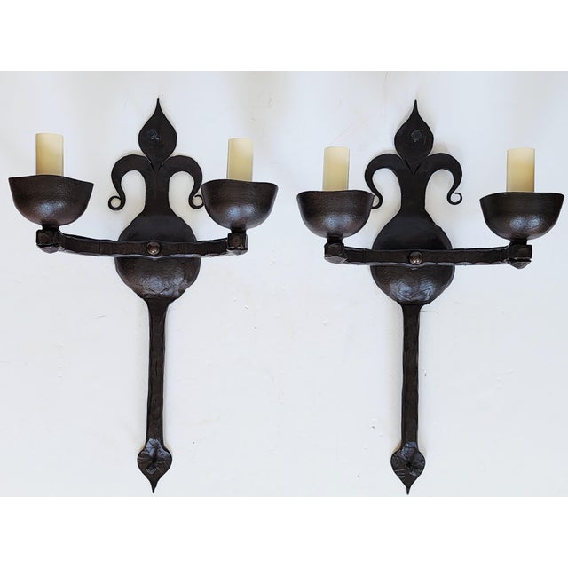 Stunning hand forged large wrought iron wall sconces by Ironware International,Inc. The Spanish Revival style wall sconces...