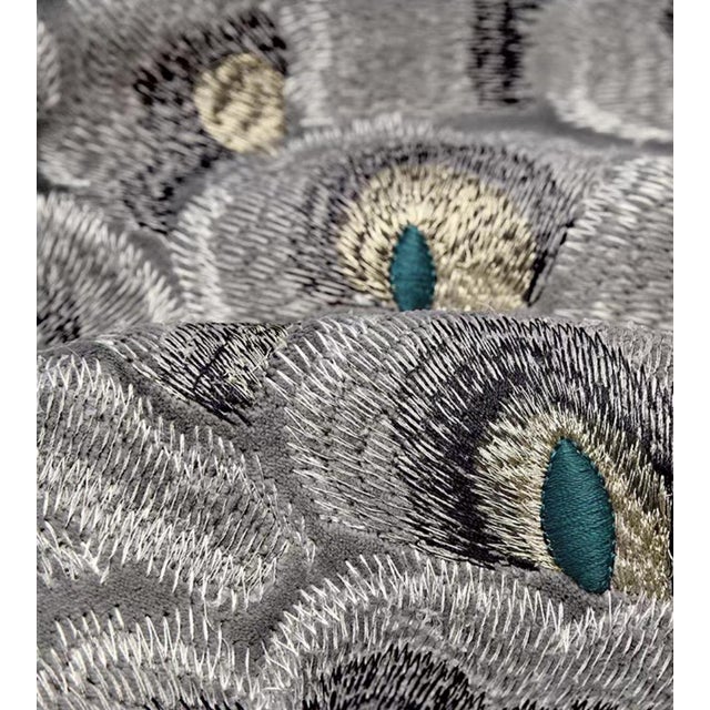 This pillow features an embroidered mysterious eye, with the pattern set against a warm taupe linen-like fabric in...