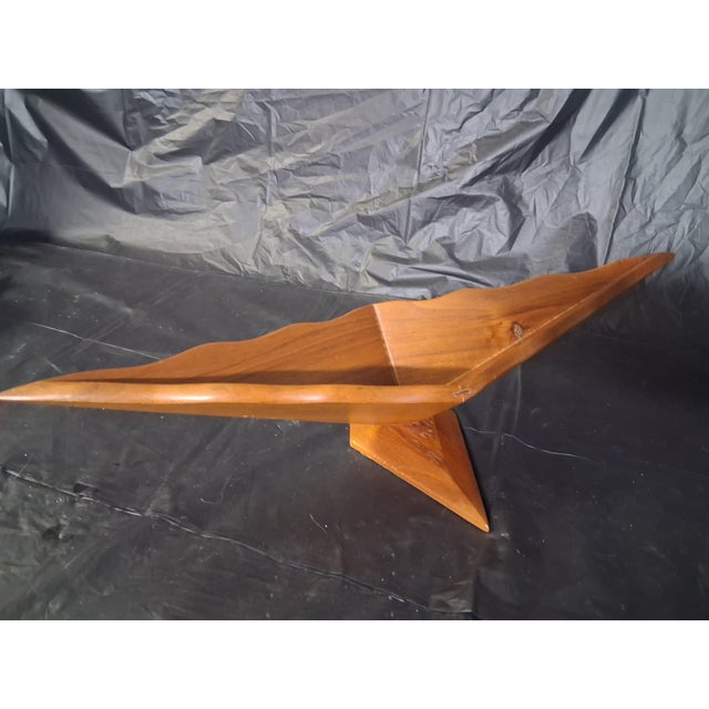 This is a vintage mid-century modern sculpted walnut tray or centerpiece bowl featuring a geometric design on a base that...