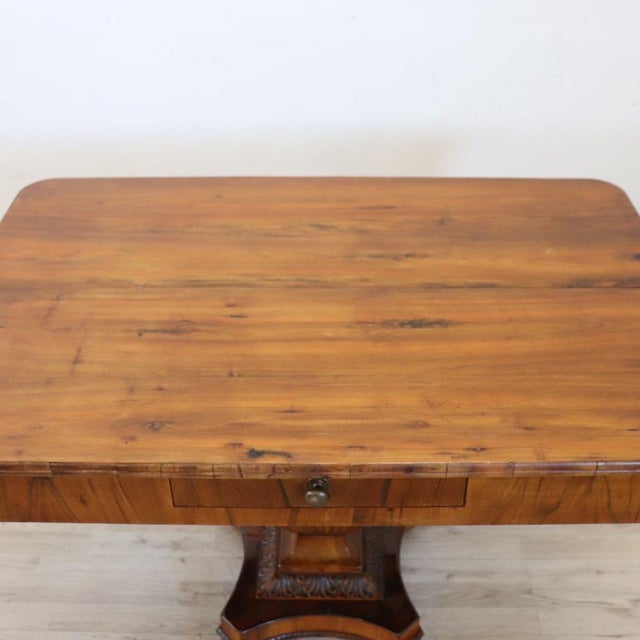 Refined antique Italian coffee table dating back to the early 19th century. It features the stylistic and construction...
