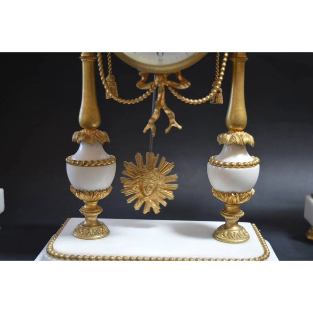 19th century French clockset. Marble and bronze, working clock. Children playing the Horn measure to 12" H x 8.5" W x 3.5"...