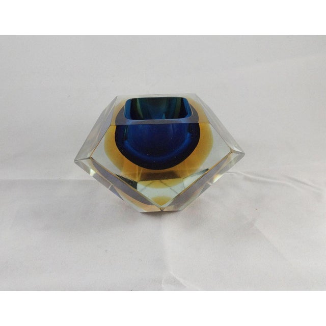 A wonderfully faceted midcentury glass bowl/paperweight, made in the Murano glassmaking technique called sommerso....