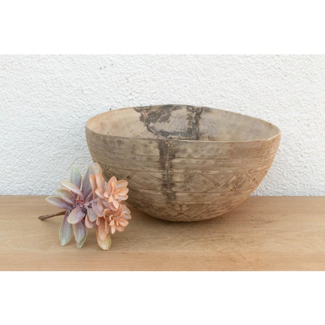 There is something deeply grounding about holding a vessel that was hewn by hand from a single block of wood. This antique...