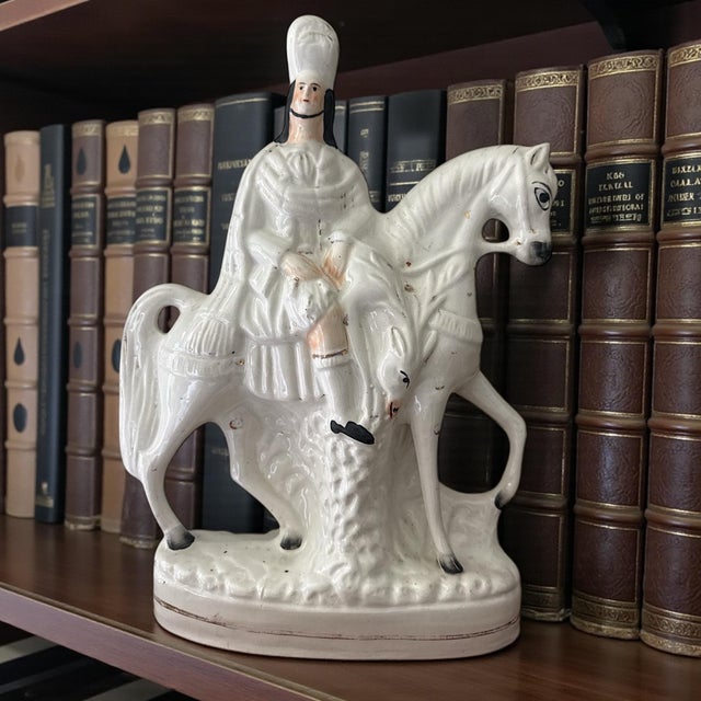 A 19th-century English Staffordshire flatback horse and rider figure, dating to the Victorian period, circa 1860–1880....