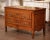This elegant antique commode sauteuse, crafted in Burgundy circa 1780, showcases the refined proportions and understated...