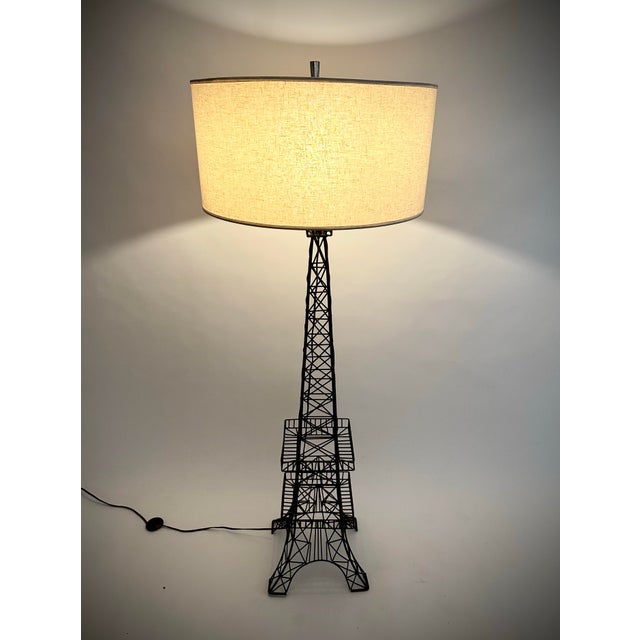 Add a touch of Paris into your home with this Eiffel Tower style floor lamp. Architectural black metal design with a...