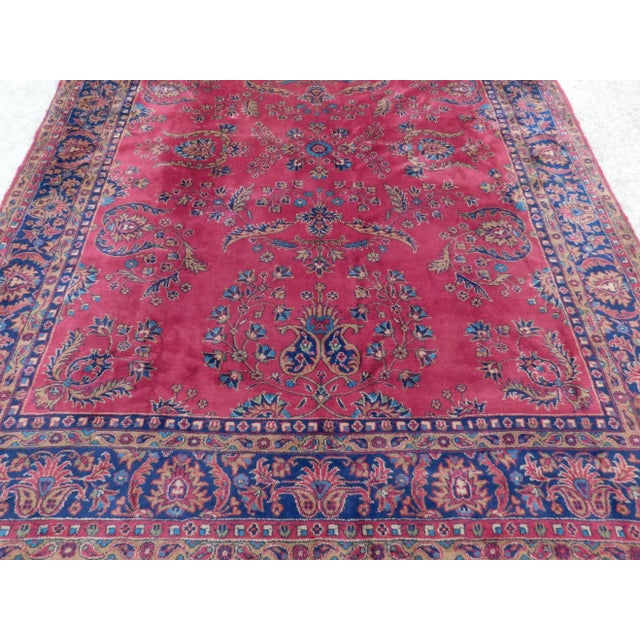 Floral decorated red field Within floral decorated blur border. Wool pile on cotton foundation.