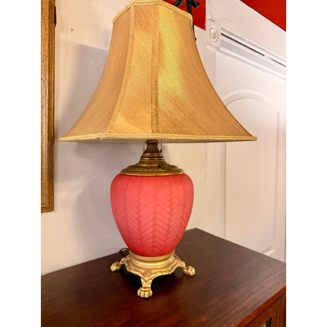 Beautiful Antique Victorian-style parlor table lamp, featuring a cranberry red “sang de boeuf” (oxblood) glass base with a...