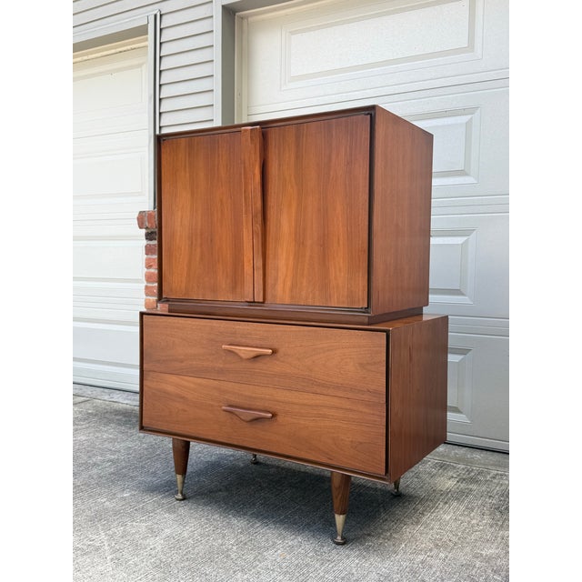 Stunning rare mid century modern gentleman’s chest (unmarked). Featured gorgeous sculpted walnut handles. The top opens to...