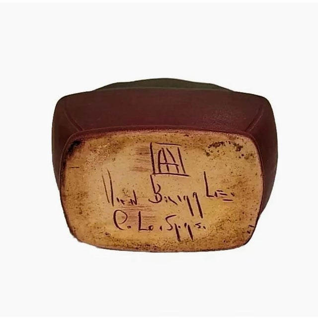 Made in the early 20th century. Matte finish and decorative features. Beautiful, signed piece.