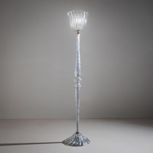 Large floor lamp in clear glass with enclosed air bubbles. The rounded, flowing base and the shade shaped like a wavy...