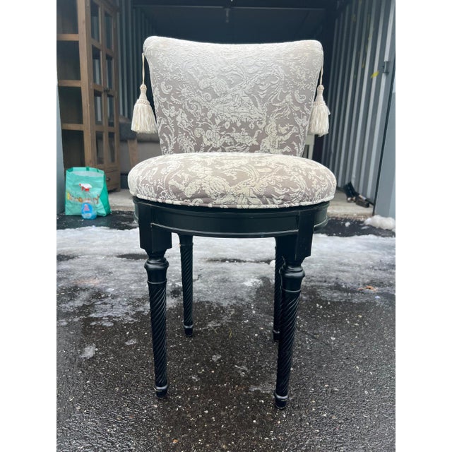 Elegant custom upholstered vanity seat from the 1980s in a custom upholstered Fabric with tassels. It features a refined,...