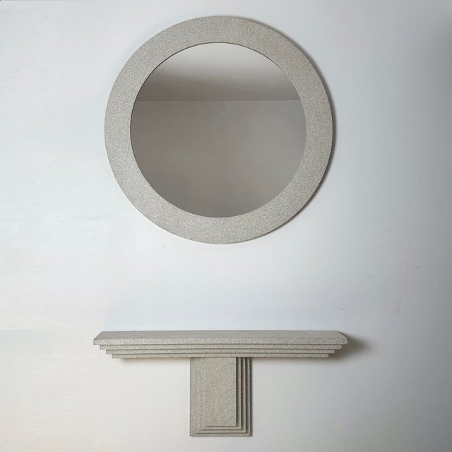 Vintage late 20th century Empire Arts round mirror and stepped postmodern wall mounted console table. Speckled grays...