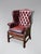 A good quality late 19th-century burgundy brown leather wing armchair in the George III style, featuring square tapering...