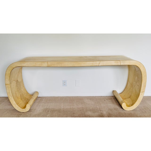 An Asian inspired scrolled console table covered in lacquered goatskin. Attributed to Karl Springer from the 70’s.