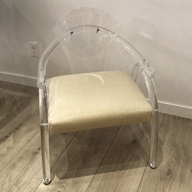 This vintage lucite chair with recently upholstered seat is attributed to American furniture designer Charles Hollis...