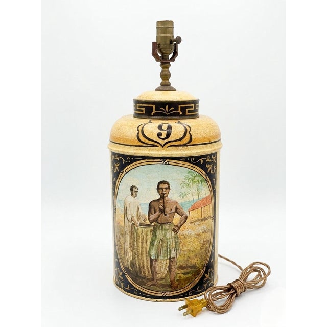 This striking table lamp is fashioned from a vintage English tole tea caddy, dating to the late 20th century (circa 1980)....