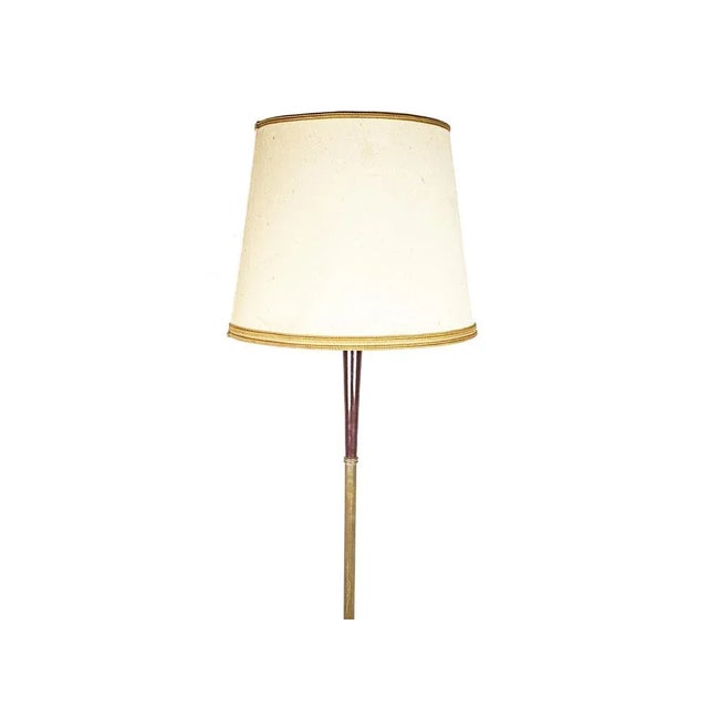 This elegant floor lamp was produced in Italy in the late 1940s. It is made from a brass structure with laquered wood...