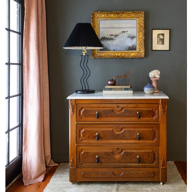 A pair of two vintage black, sculptural, Memphis-style squiggle table lamps feature a round base supporting three wavy...