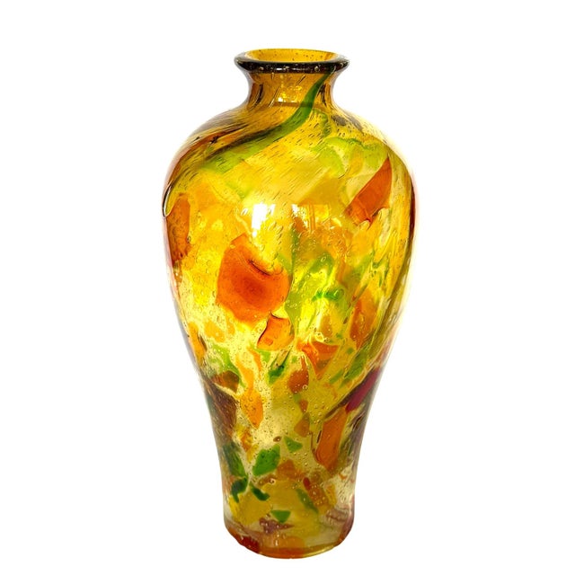 The bottle vase exemplifies the rich tradition of Italian art glass, particularly the millefiori (thousand flowers)...