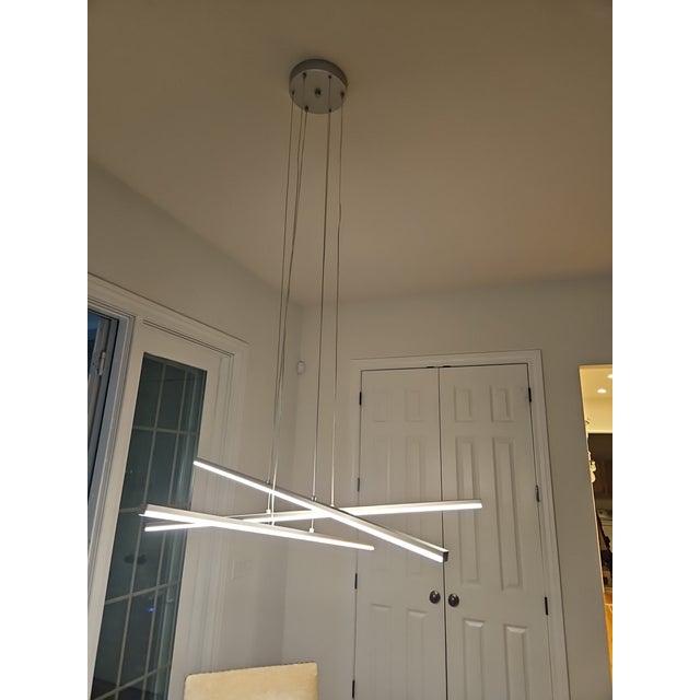 The Sonneman 2763.16 Aluminum Stix 3-Arm LED Hanging Chandelier Pendant Light is a modern and stylish lighting fixture...