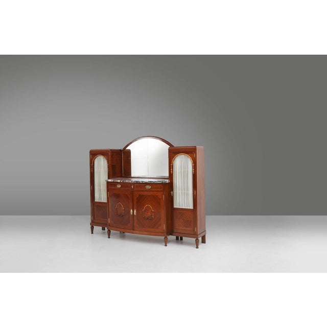 A distinguished Art Deco cabinet attributed to the renowned Belgian firm De Coene Frères, crafted in the 1930s and...
