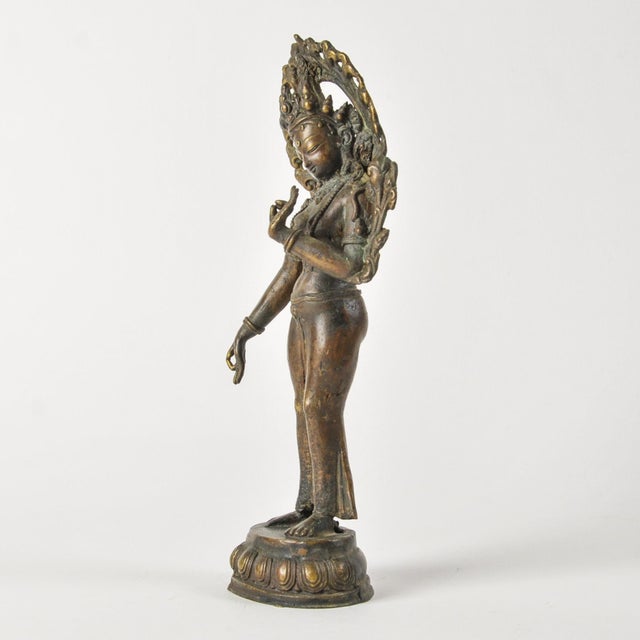 Incredible old bronze statue of the beautiful Goddess Tara in standing posture with ornate details, richly adorned, with...