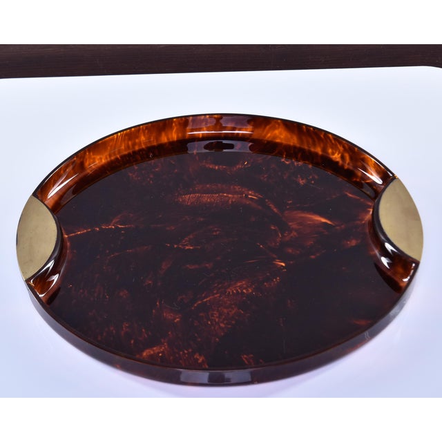 Found in Italy, this round faux tortoise tray dates from the 1970s. Tray material appears to be acrylic and is trimmed in...