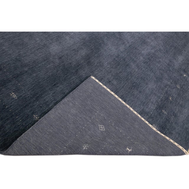 Beautiful modern Gabbeh style hand-Loom wool rug with a blue field. This Gabbeh-style rug has white accents in a gorgeous...