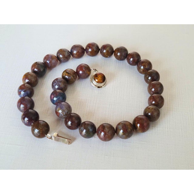 This beautiful necklace is crafted from natural pietersite, a rare gemstone known for its deep energy and unique color...