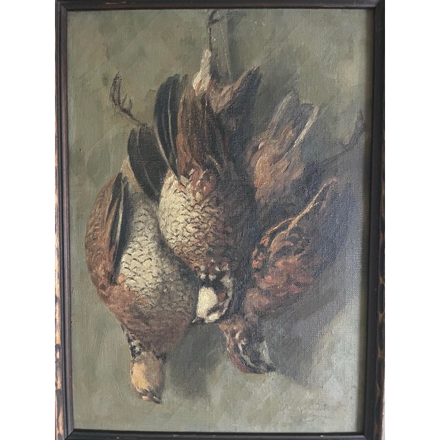 This sporting still life is of a brace quail hanging by their feet. It is a painting of oil on canvas. And there is some...