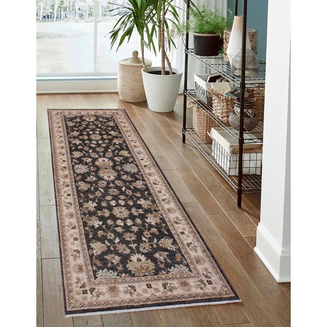 Enhance the ambiance of your home with this magnificent Persian-influenced Turkish hand-knotted rug made by skilled...