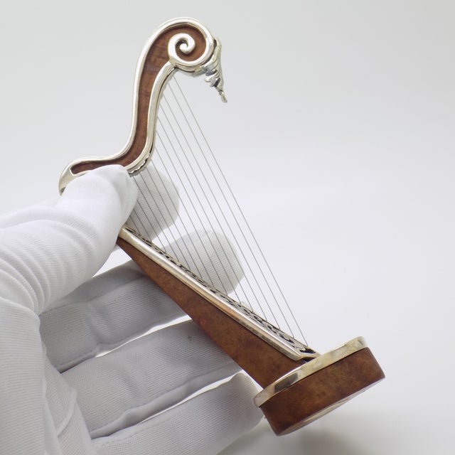 Celebrated for its melodic poise and graceful silhouette, this vintage italian figurine depicts a classical harp rendered...