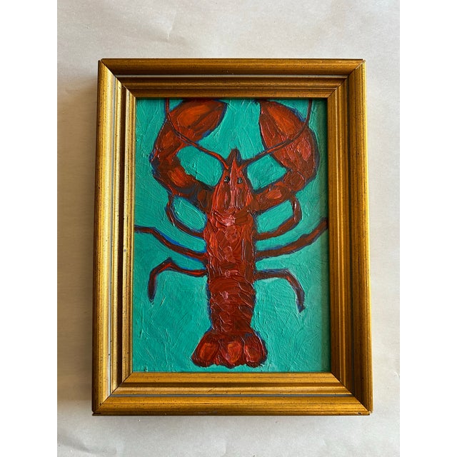 Original oil painting of a lobster on a turquoise blue background. In gold frame. Signed and titled “Lobstah” on the back.