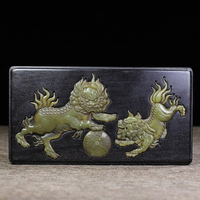 A beautifully crafted Chinese rectangular box made of dark, dense wood, likely Black Zitan (Heitan). The box features a...