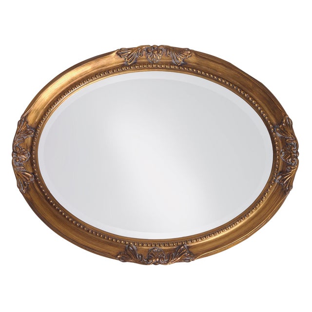 The Queen Ann Mirror features an antique gold finish. The oval frame is made from wood and is accented with a beaded...