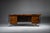 This striking executive desk is veneered in beautifully patterned Makassar ebony and elevated on chromed, futuristically...