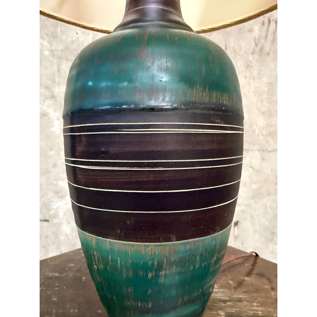 Handsome vintage mid-century ceramic table lamp with a great graphic profile. The turned urn-form body is glazed in a soft...