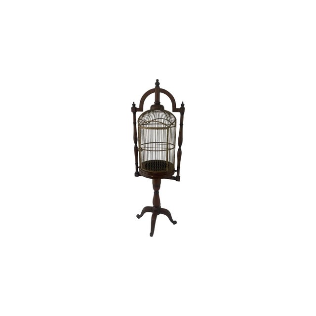 The English Campaign Style Hanging Bird Cage is a large, vintage decorative collectible with a Victorian-style design....