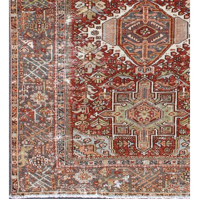 Measures: 4'8 x 6'2. Antique Persian Heriz Rug Featuring Geometric Medallion Design In Rust and Ivory. Keivan Woven Arts /...