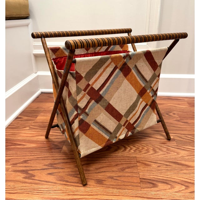 Simple organic materials of fabric and wood comprise this vintage sewing basket. A bold, criss cross pattern in colors of...
