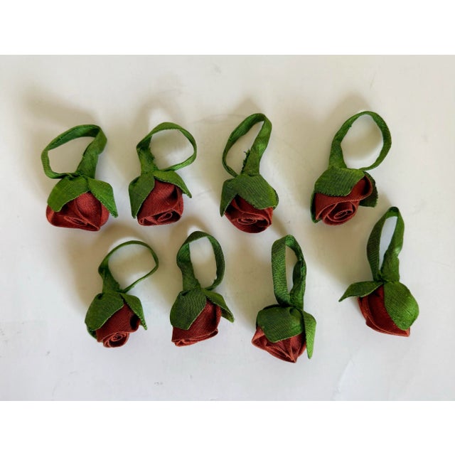 Here is a lovely set of EIGHT red rosebud napkin rings that are made from a silk-satin fabric. As you can see in the...